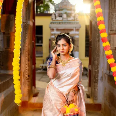 A classic Onam look featuring our simple yet elegant gold-finish necklace set. This photo, taken in a temple corridor, shows how our jewellery is perfect for traditional festivals.