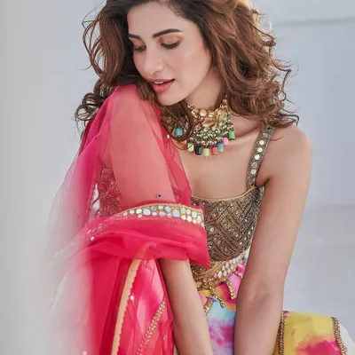For this vibrant, multi-coloured lehenga, I kept the makeup glowing and fresh with a touch of colour on the lips. This look is ideal for a sangeet or mehendi ceremony.