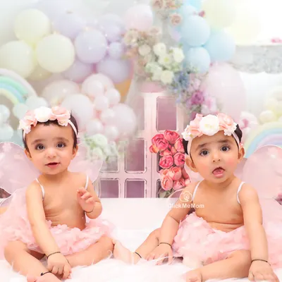 Two little fairies, twice the magic. This portrait of twin sisters in our pastel-themed fairy setup is a beautiful memory of their special bond.
