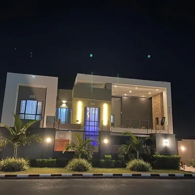 This home's facade comes alive at night. I use strategic exterior lighting to highlight the architectural lines, textures, and landscaping, creating a warm and dramatic presence after dark.