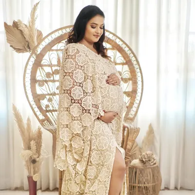 Embrace your inner boho goddess with our Juene gown. This chic kaftan-style dress is made from beautiful lace and looks perfect in our wicker peacock chair.