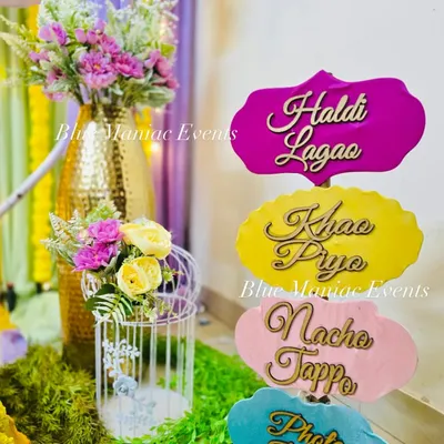 Fun and quirky props for your Haldi ceremony, with signs like 'Haldi Lagao', 'Khao Piyo', and 'Nacho Tappo' to get everyone in the festive spirit.