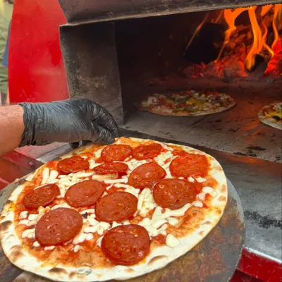 Here’s a look at my fiery oven where the magic happens. This pepperoni pizza is just about to go in, ready to be transformed into a crispy, cheesy masterpiece.