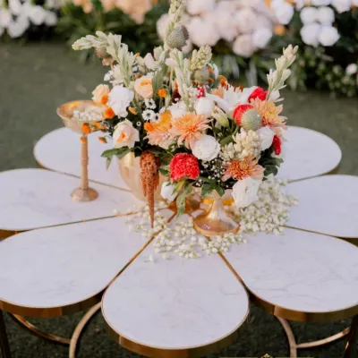 A centerpiece that is a work of art. I designed this flower-shaped marble table and topped it with a vibrant floral arrangement, creating a detail that is both unique and incredibly chic.