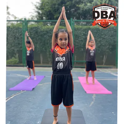 This is what focus looks like. A young DBA athlete holds a pose during our yoga session, building the mental discipline that translates directly to the basketball court.
