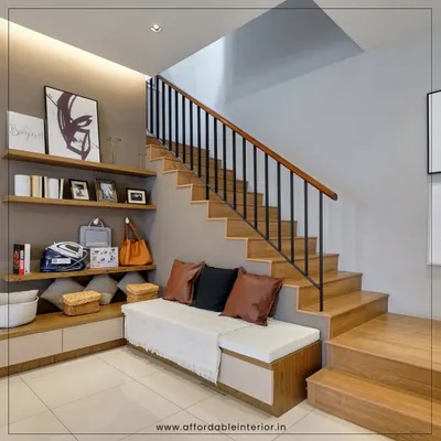 We transformed the often-neglected space under the stairs into a functional and stylish foyer with a built-in bench for seating and storage, along with open shelves for decor.