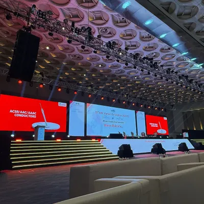 A wide view of our setup for the AIBI Annual Convention. This showcases the large-scale lighting rig, speaker systems, and expansive stage designed to accommodate panel discussions and keynote speakers in a grand hall setting.