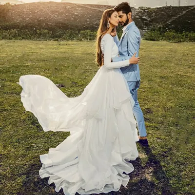 A truly epic shot from our pre-wedding shoot in Sonmarg, Kashmir. The bride's flowing white gown against the vast green meadow and distant mountains creates a breathtaking, fairytale-like image. This is what destination photography is all about.