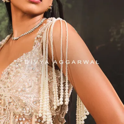 A macro shot of the Nuray Gown's shoulder detail. I designed these cascading tassels with hundreds of hand-strung pearls to create fluid, elegant movement.