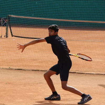 A junior player executing a powerful forehand during a tense semi-final match. The focus and technique on display were outstanding.
