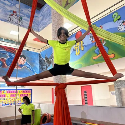 A perfect split held high on the silks demonstrates amazing flexibility and strength. Our classes focus on achieving these milestones safely and progressively.