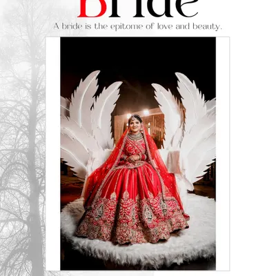 A dramatic and regal bridal portrait. The bride is seated on a throne-like chair with large white wings, creating a stunning, high-fashion look that makes a bold statement.