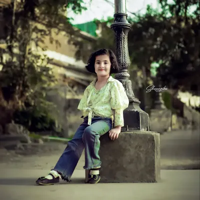 My daughter posing like a little model by a vintage lamp post. This kids portrait session was all about having fun and letting her personality come through.