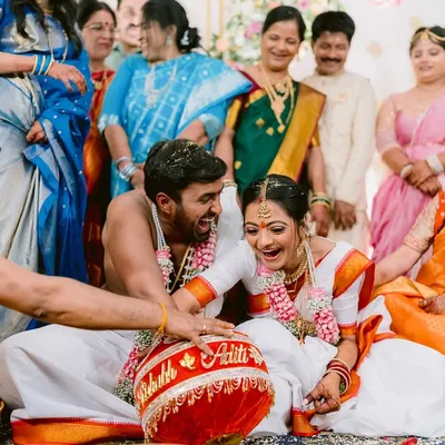 A moment of pure, unscripted laughter during a fun wedding game at Aditi and Rishabh's Telugu wedding. These are the moments that truly show a couple's personality.