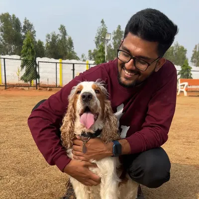 There's nothing better than a hug from a happy dog. Here I am with a beautiful Cocker Spaniel, sharing a smile after a fun play session in our daycare.