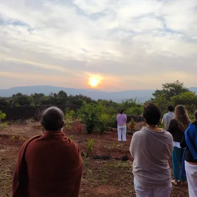 A group of students and I begin the day with silent meditation, facing the sunrise at our Amboli ashram. This practice, part of our ongoing yoga retreats, helps cultivate inner peace and awareness.