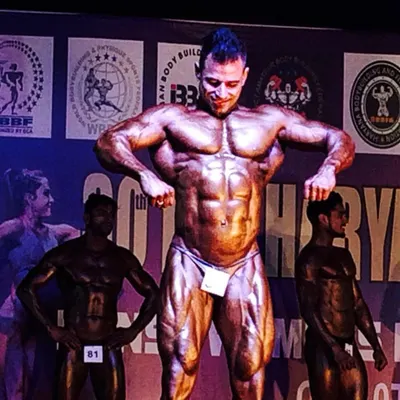 An athlete in his element, hitting a most muscular pose on stage. This is the culmination of months of strict diet and training, all for this moment.