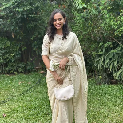 Our client looking absolutely radiant in our fancy tissue saree with pearl scallop work. It's perfect for an elegant, understated look.