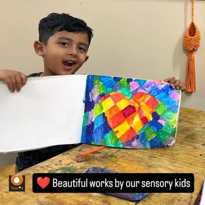This vibrant heart mosaic is a beautiful exploration of color blocking. The student's joyful expression shows how proud he is of his work, and we are proud of him too!