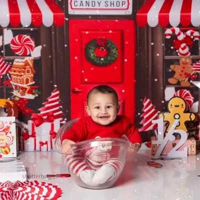 This happy baby is all smiles sitting in a giant teacup in our festive red and white Candy Land theme.