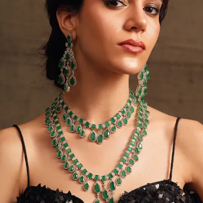 Diamond brilliance for your grandest nights. This layered diamond and emerald necklace is the epitome of cocktail glamour, designed to catch the light from every angle.