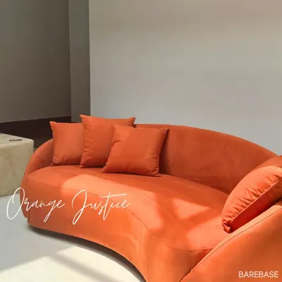 We believe furniture should be fun. This bright orange, curved sofa is a perfect example of how we play with color and form to create pieces that are both comfortable and conversation-starters.