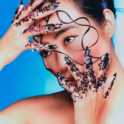 A symphony of texture and light. For this "Seraphine" editorial, I designed intricate, jeweled nails and a wet-look, sculpted hairstyle to create a high-fashion, avant-garde narrative.