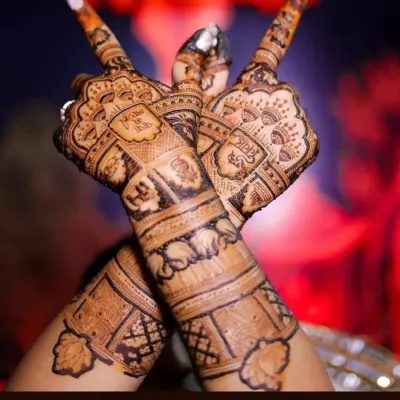 This design showcases how I can weave personal elements like a wedding hashtag into traditional mehandi patterns. The back of the hands are covered in detailed geometric and floral work.