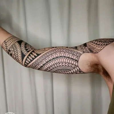 A full freehand Maori sleeve, showcasing intricate patterns and bold lines. Each element is designed to flow with the arm's muscles, creating a cohesive and powerful piece of body armor that tells a personal story.