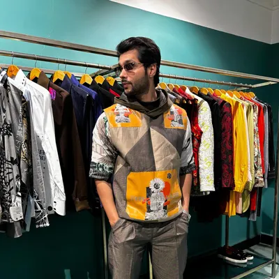 The Solar Flare Set, a blend of casual cool and urban sophistication. It features a printed tee, a suede hoodie with nappa patches, and embroidered trousers for a standout look.