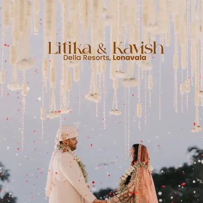 A magical varmala moment for Litika and Kavish at Della Resorts, Lonavala. The mandap, with its cascading floral strings against the open sky, created a truly ethereal setting.