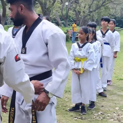 I believe in teaching by example. Here, I am lining up my young students for a drill during an outdoor park session, ensuring they learn the importance of order and paying attention.