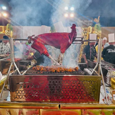 The centerpiece of our live barbecue station, a whole tandoori-spiced goat slow-roasting over charcoal. The sight and smoky aroma create an interactive and theatrical dining experience that guests talk about long after the event.