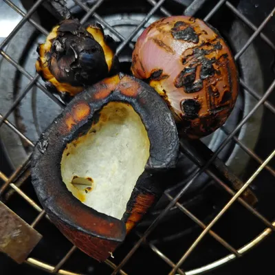 The secret to the deep, smoky flavour in dishes like Chicken Kale Sukkha is charring the ingredients. Here, I'm roasting dry coconut, onion, and garlic directly on the flame before grinding them into a masala.