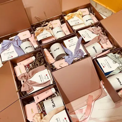 A closer look at our bridesmaid proposal hampers. Each box is personalized with a name and filled with curated items, then tied with a beautiful satin ribbon. We use different colored ribbons to match the bride's theme.
