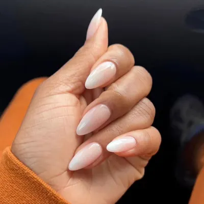 A perfect example of a classic baby boomer manicure, with a seamless ombre blend from a soft pink base to a milky white tip on almond-shaped nails.
