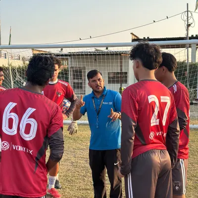 Our coach leading a team talk during a training session. Clear communication and strategy are just as important as physical fitness.