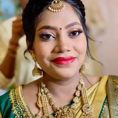 A beautiful mom-to-be, glowing for her Seemantham ceremony. I used warm tones and a classic red lip to create a look that is both traditional and radiant.