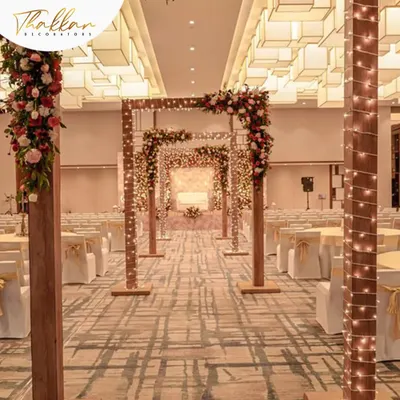 Imagine walking down an aisle like this. I created this indoor wedding aisle with a series of wooden arches wrapped in fairy lights, leading to a beautifully decorated mandap.