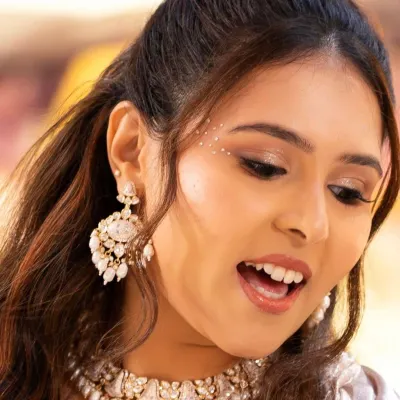 A close-up on the sangeet glam. This shot highlights the shimmering eyeshadow, the subtle wing, and the delicate face gems that add a touch of sparkle and magic to the look.