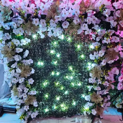 This ready-to-book backdrop features a green grass wall with a border of white flowers and golden accents, illuminated with built-in fairy lights. It's a beautiful and easy way to create a festive corner. Only 5 pieces left!
