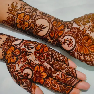 A beautiful henna design adorned with hibiscus flowers. This is one of my favorite floral motifs to create, with its delicate petals and leaves covering the hand and arm.