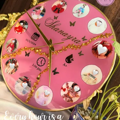 Celebrate every precious moment with a custom baby clock. This bright pink resin clock features twelve photos from baby Shanayra's first year, along with her birth details, making it a perfect centerpiece for a nursery.