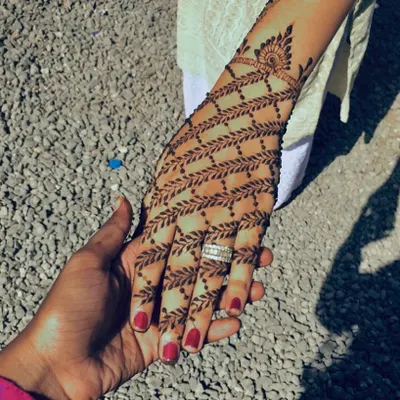 A very modern and elegant design featuring a net of delicate leafy vines covering the back of the hand.