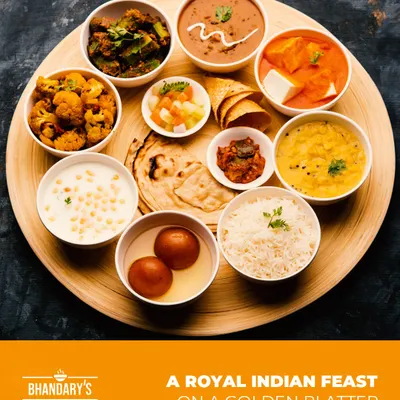 A royal Indian feast on a golden platter. This thali represents the variety and richness of our menu, offering a complete meal experience.