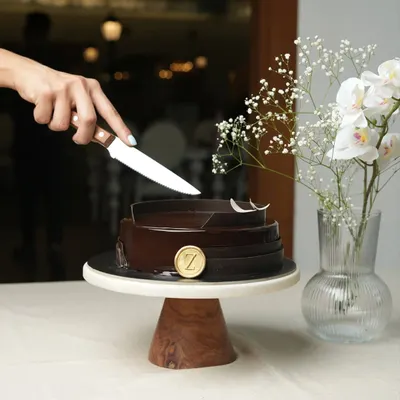 The moment before the first slice. My Belgium Chocolate Cake, with its glossy finish and elegant chocolate collar, sits ready to be the star of your celebration.