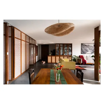A sun-drenched dining and living space from a recently completed interior project, showcasing the beautiful interplay of natural light, warm wood, and curated furniture.