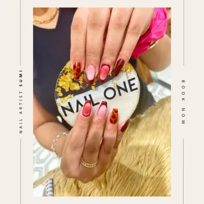 This trendy design by our artist Sumi features a dramatic ombré from nude to deep red, framed with a tortoise shell pattern. It's a bold and fashionable look that combines multiple techniques.