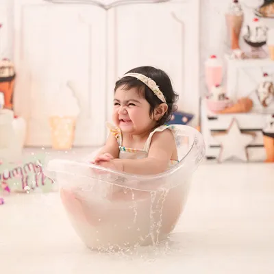 The pure joy of splashing in a warm milk bath. This little one's scrunched-up, happy face is absolutely infectious.