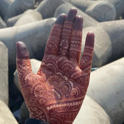 The beautiful result of a mature henna stain, seen here against a natural background. The color is a deep, rich maroon, which shows the quality of the natural paste.